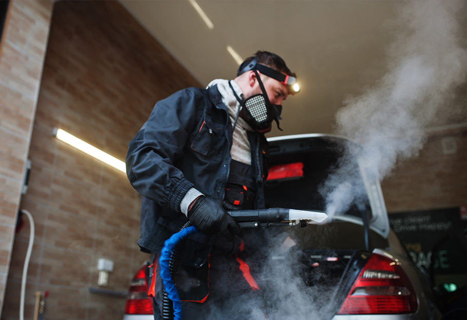 Automotive cleaner wearing a respirator