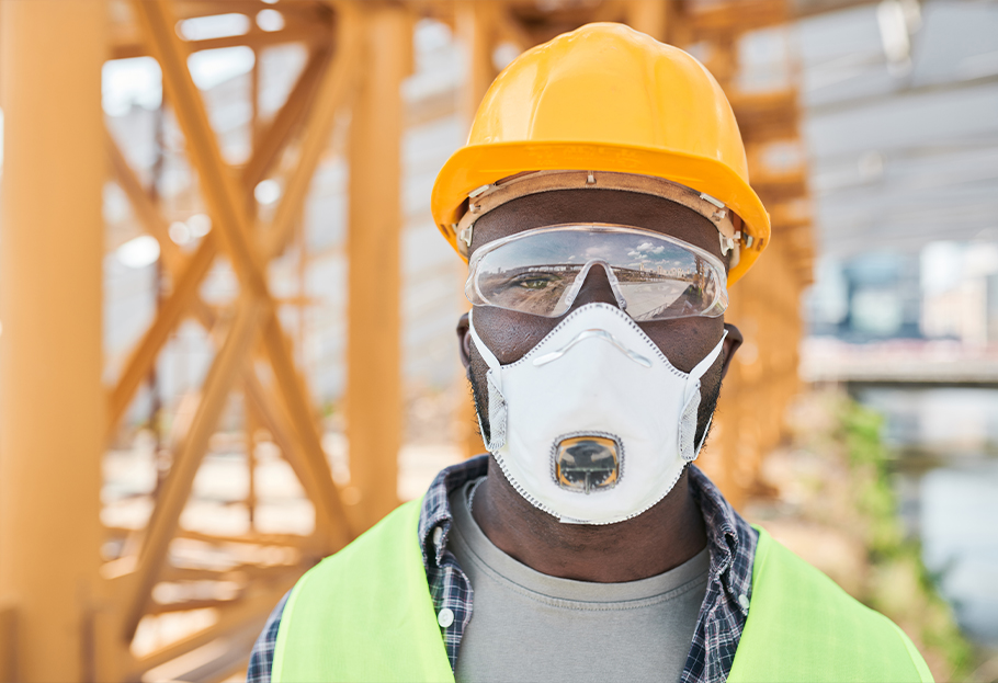 Construction worker on job site with respirator